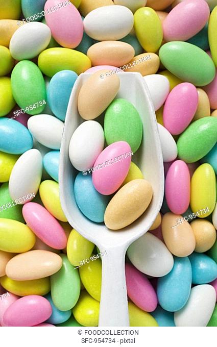 Sugared almonds, some in scoop