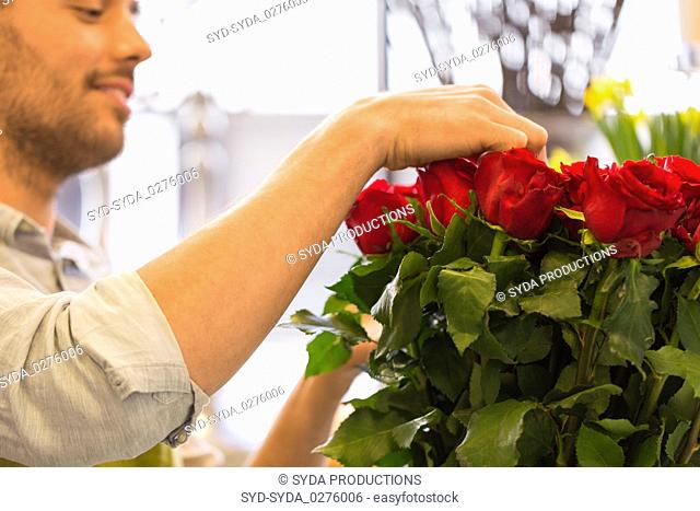 florist or seller setting red roses at flower shop