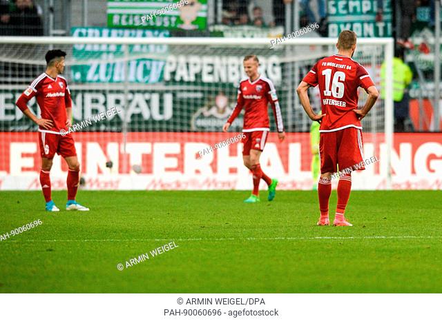 dpatop - Ingolstadt's Alfredo Morales (l-r), Florent Hadergjonaj and Lukas Hinterseer look downcast at the end of the German Bundesliga soccer match between FC...
