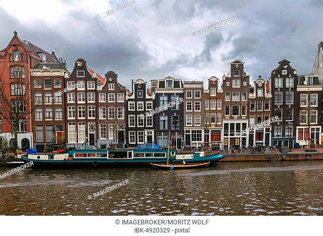 Canal with boats and historic houses, Amsterdam, North Holland, Netherlands