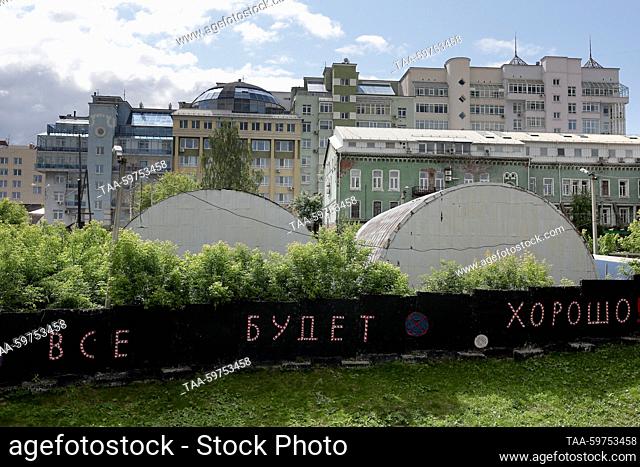 RUSSIA, PERM - JUNE 11, 2023: A view of residential buildings in Sovetskaya Street. The message on the fence reads: ""Everything Is Going To Be All Right""