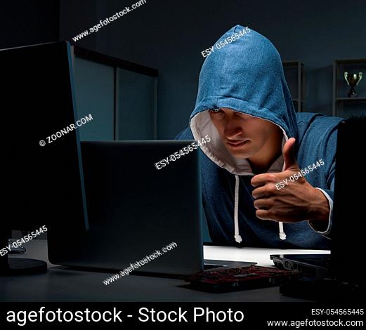 The hacker hacking computer at night