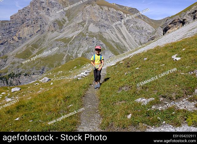 Portrait of child during a hike in the paths of the Stelvio National Park, Italy