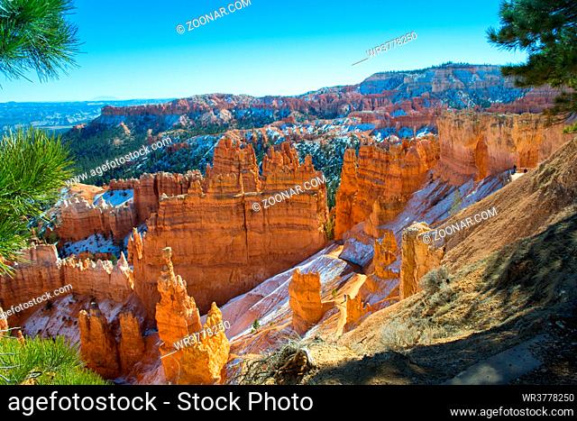 Snow topped Bryce canyon with hoodoos on a sunny day during golden hour, national park, Utah, USA