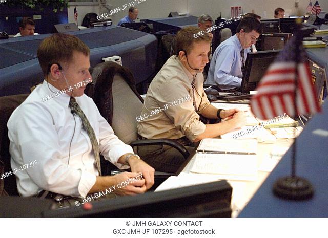This view inside Houston's Mission Control Center shows, from the left foreground, astronauts Christopher J. Ferguson and Kenneth T