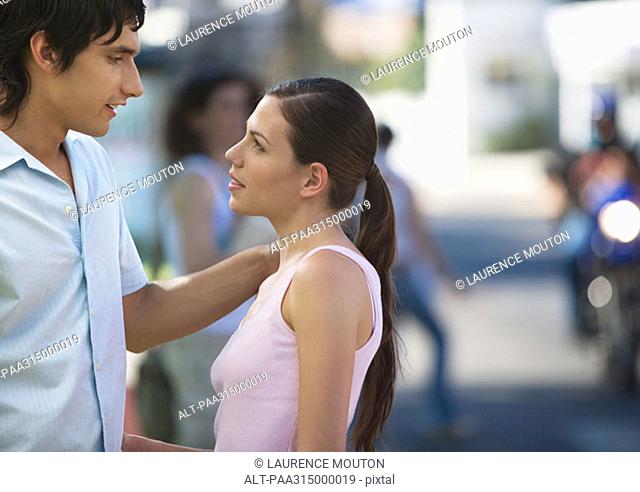 Young couple talking to each other in urban environment