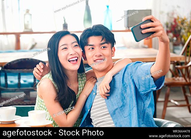 Young couples with a cell phone camera