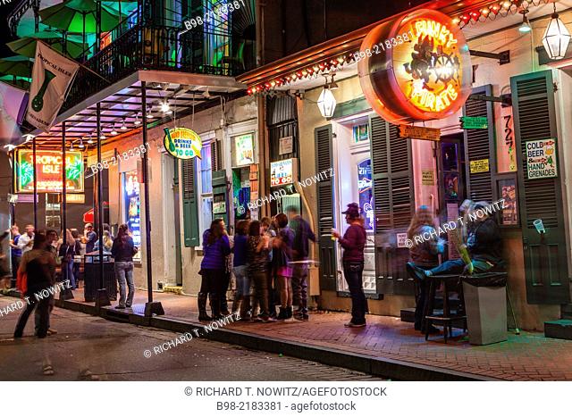 Tourists enjoy the nightlife on Bourbon St