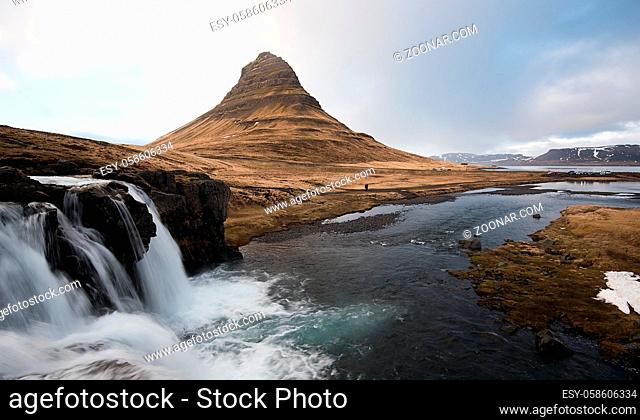 Kirkjufellsfoss waterfalls with the Kirkjufell mountain , at Grundarfjordur, on the Snaefellsnes peninsula in Iceland
