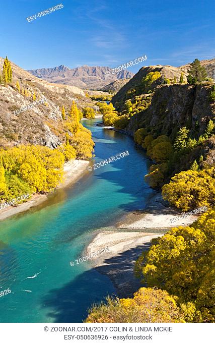 The Kawarau River flows from Lake Wakatipu through the gorge to Cromwell and Lake Dunstan in Otago, New Zealand. The gorge is seen here in autumn