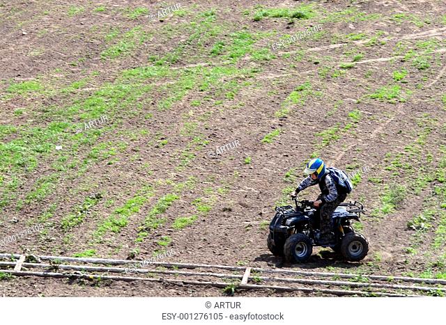 young man on quad bike during a race