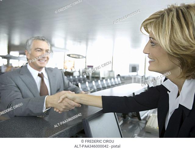 Airline attendant shaking hands with passenger