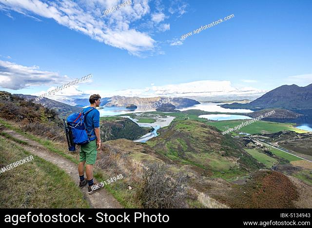 Hiker on the trail to Rocky Peak, views of Wanaka Lake and mountains, Glendhu Bay, Otago, South Island, New Zealand, Oceania