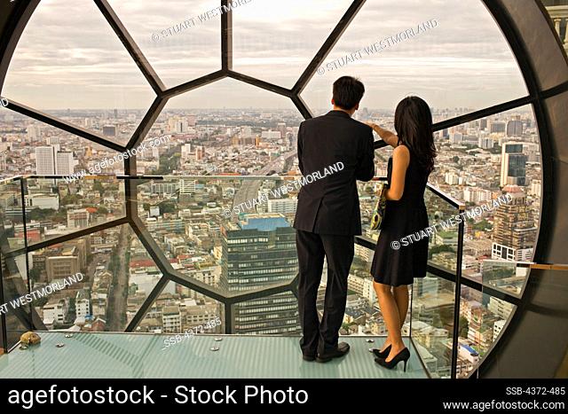 A couple at the award-winning Breeze Restaurant, at top of Lebua at State Tower, Silom Road, Bangkok, Thailand