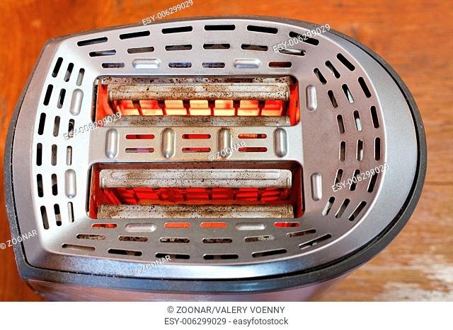 two slices of bread toasting in metal toaster