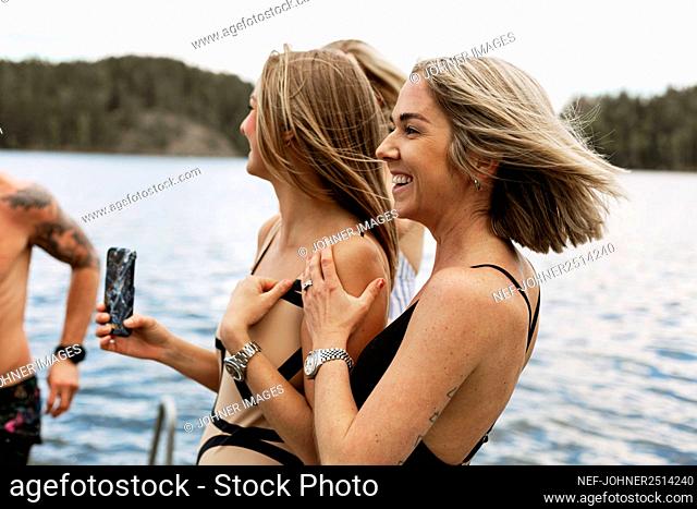 Happy female friends at lake
