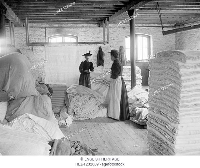 Early Blanket Factory, Witney, Oxfordshire, 1898. Women cutting blankets out of pieces of finished cloth. The Witney Blanket was famous for centuries