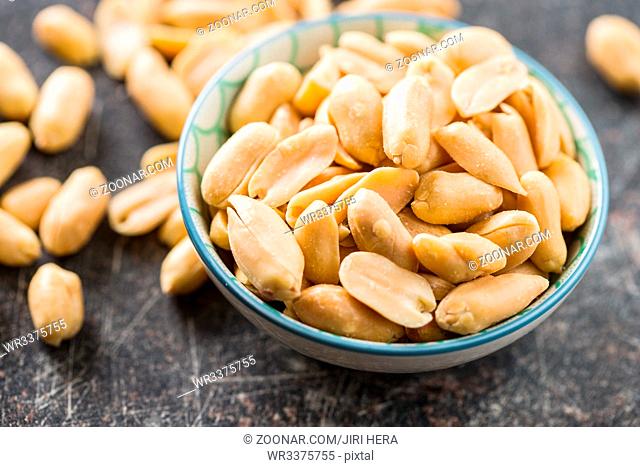 Salty roasted peanuts in bowl
