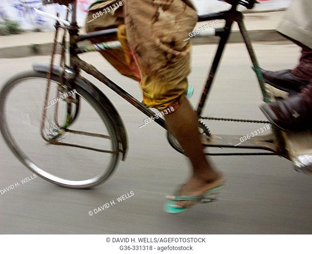Bicycle rickshaw driver at work. Dhaka, Bangladesh