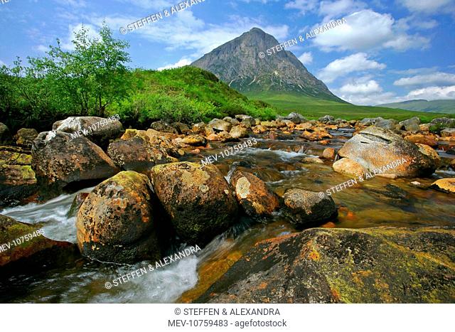 Mountain scenery - Buachaille Etive Mor and Coupal river at low water level with red rocks and boulders visible
