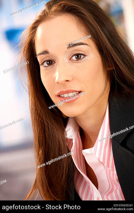 Closeup portrait of young beautiful woman looking at camera