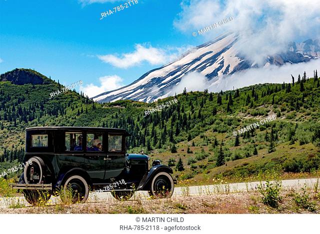 Beautifully restored Vintage American car passing Mount St. Helens, part of the Cascade Range, Pacific Northwest region, Washington States