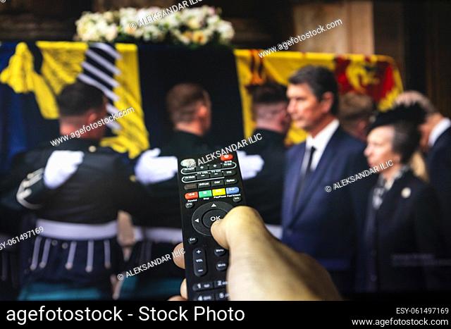 Belgrade, Serbia - September 12, 2022: Queen Elizabeth II coffin carried in to the Palace of Holyroodhouse, Scotland. Watching news on tv about late Queen of...