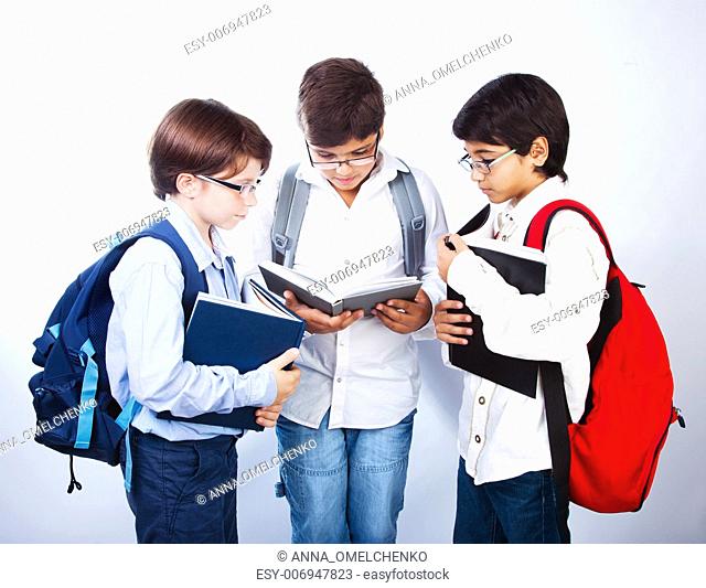 Three smart boys read books, classmates make homework, schoolboys learning lesson, clever three male pupil in glasses isolated on white background