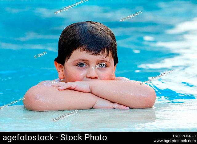 Beautiful baby in the swimming pool on the summer