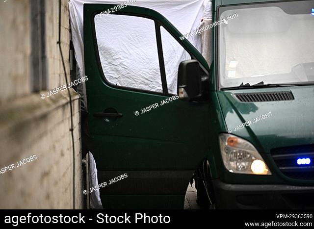 A van with an open door and white drapes is seen as the suspects arrive for a session of the council chamber at the justice palace in Mechelen
