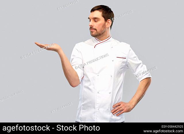 male chef holding something on hand