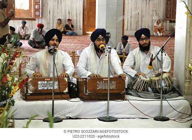 Delhi, India: men playing holy music at Gurdwara Bangla Sahib, the most prominent Sikh house of worship in Delhi