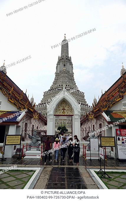 27 February 2018, Thailand, Bangkok: Visitors walking through the entrance of the central prang (temple tower) of Wat Arun (Temple of Dawn)