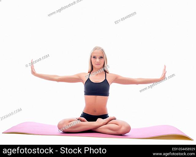 Image of attractive slim woman doing yoga on mat in studio