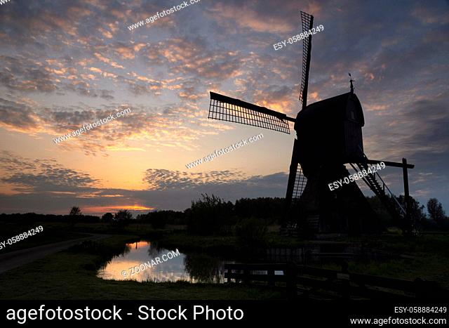 Windmill the Noordenveldse Molen seen just before sunset is situated between the Dutch villages Dussen en Almkerk in the province Noord-Brabant
