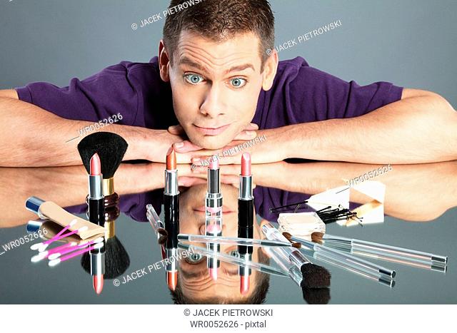 Young man looking at cosmetic products