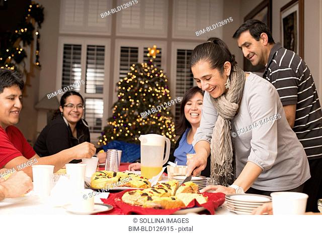 Hispanic family enjoying traditional Christmas dessert