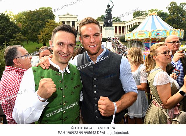 22 September 2019, Bavaria, Munich: Oktoberfest 2019, the kickboxing coach Mladen Steko (l) and the kickboxing world champion Sebastian Preuss present...