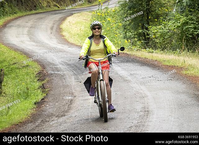 Woman, 70, bicycling on Saturna Island, BC, Canada