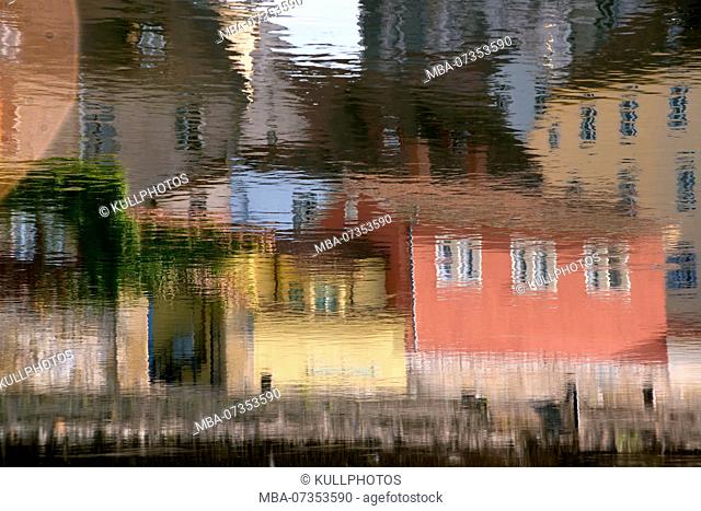 Houses reflecting in the water of the Danube in Regensburg