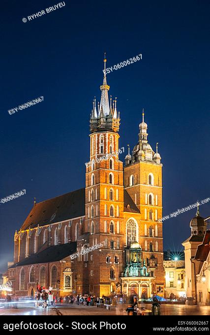 Krakow, Poland. Evening Night View Of The St. Mary's Basilica And Cloth Hall Building. Famous Old Landmark Church Of Our Lady Assumed Into Heaven