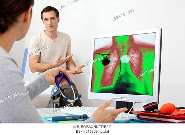 CARDIOLOGY CONSULTATION MAN Models. On screen, colorized x-ray of a patient carrying a pacemaker, and affected by a hiatal hernia