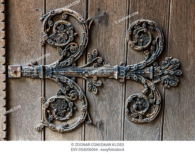 Iron ornament on a wooden church door of Chatellerault in France
