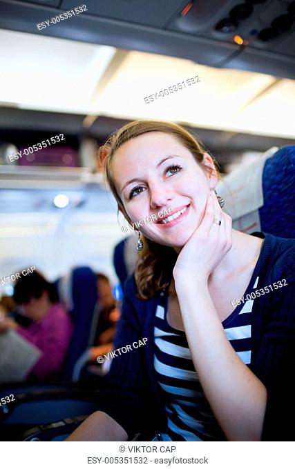 Pretty young female passenger on board of an aircraft