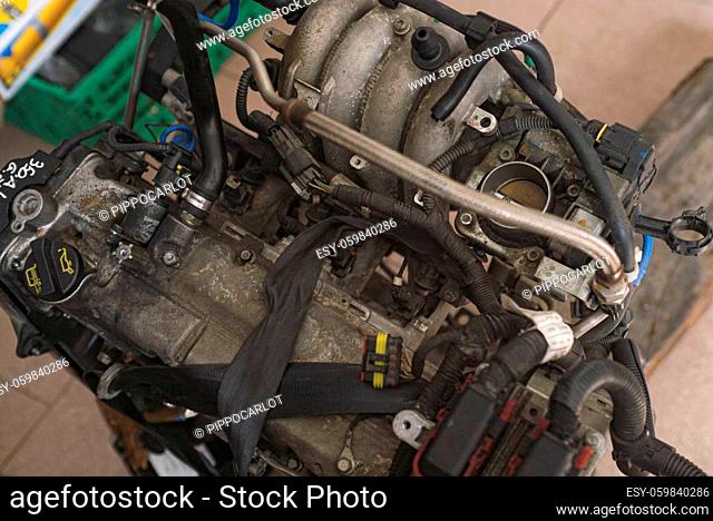 Detail of Old broken car engine at the junkyard