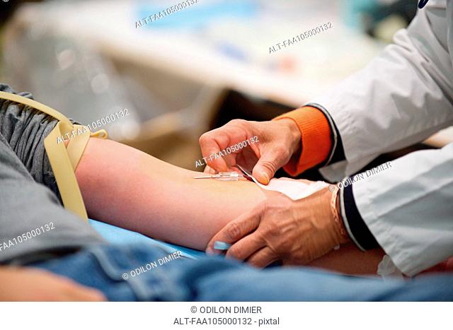 Person giving blood, close-up