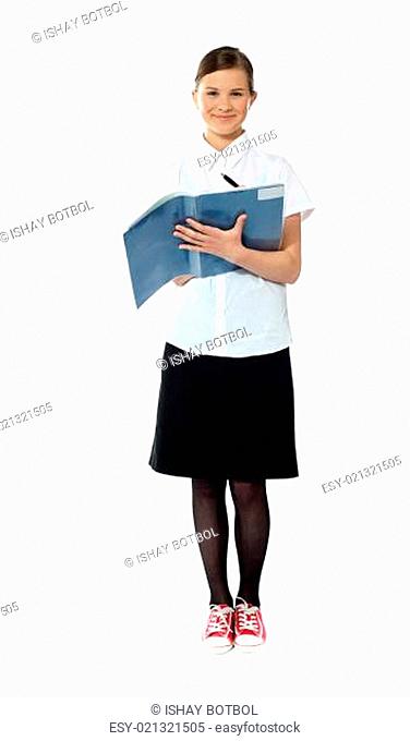 Full length portrait of smiling girl doing homework