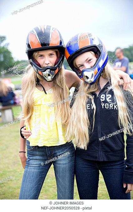 Teenage girls in motorbike helmets