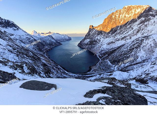 View of Oyfjorden during the last sun illuminating the peaks. Barden, Mefjordbotn, Mefjorden, Senja, Norway, Europe