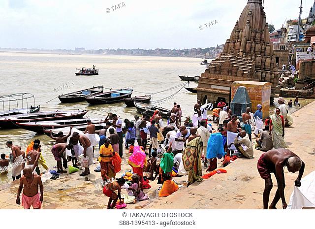 Pilgrims bathing at the ghat by the Ganges river